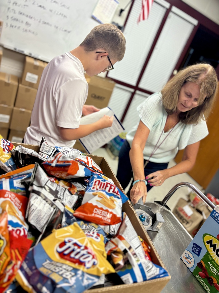 Students pack food bags.