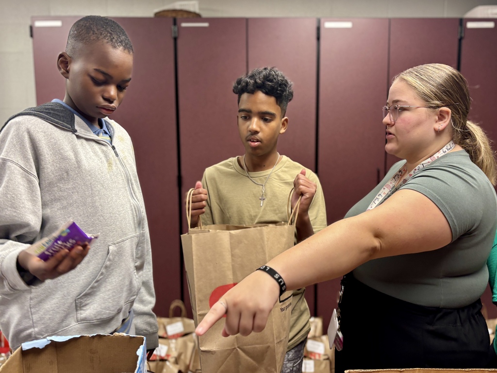 Students pack food bags.