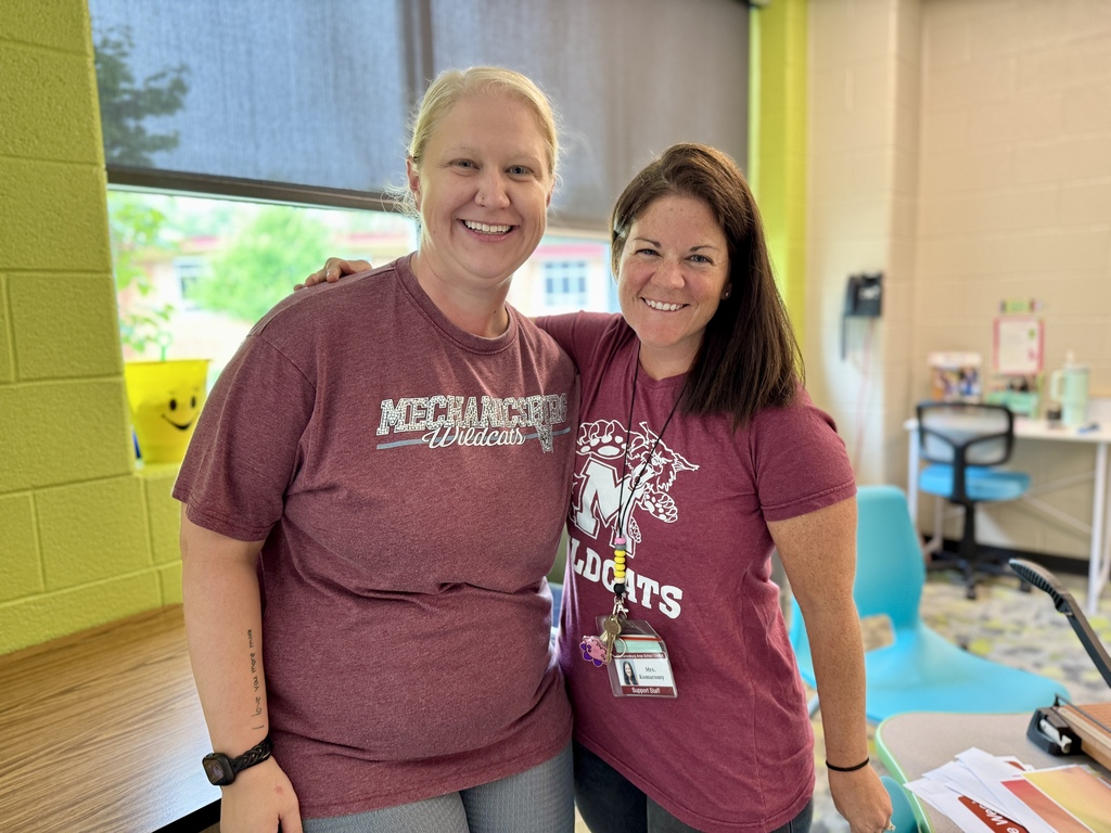 Two ladies proudly wear their maroon shirts.