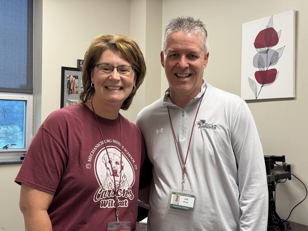 A man and woman proudly wear maroon and steel shirts.