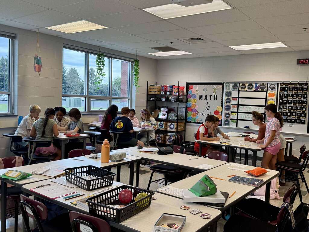Students work together on math problems in a middle school classroom.