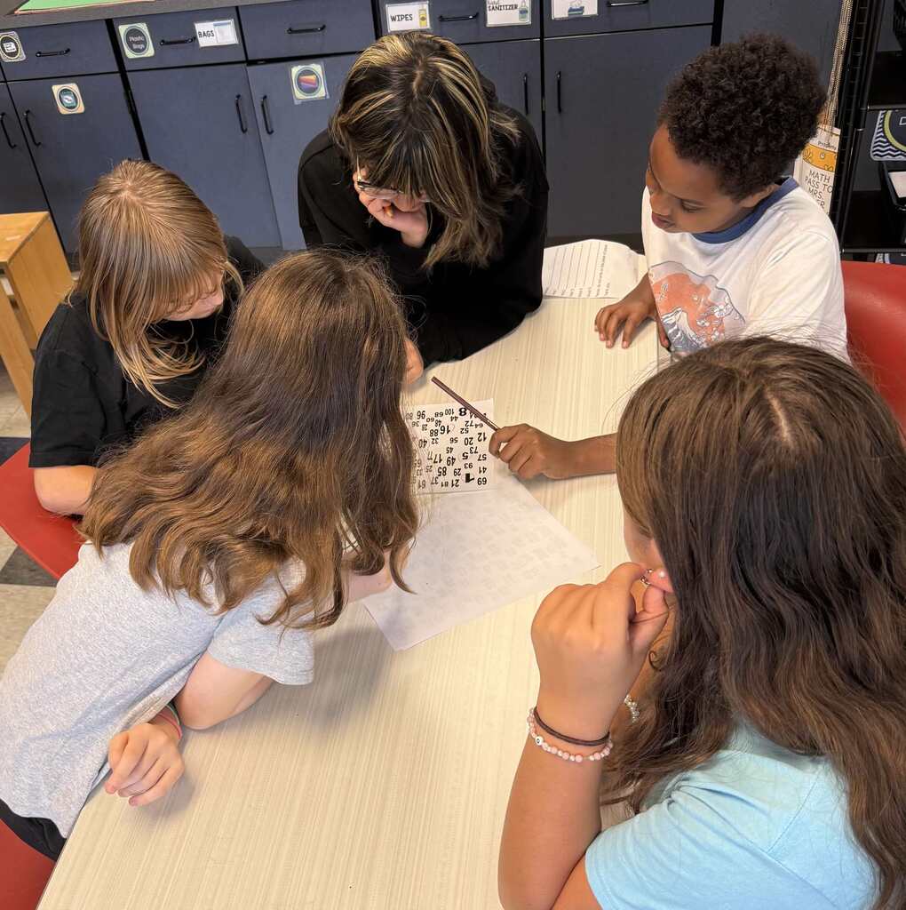Students work together on math problems in a middle school classroom.