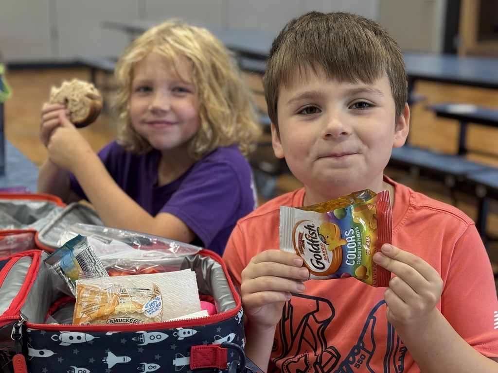 Students smile together at lunch.