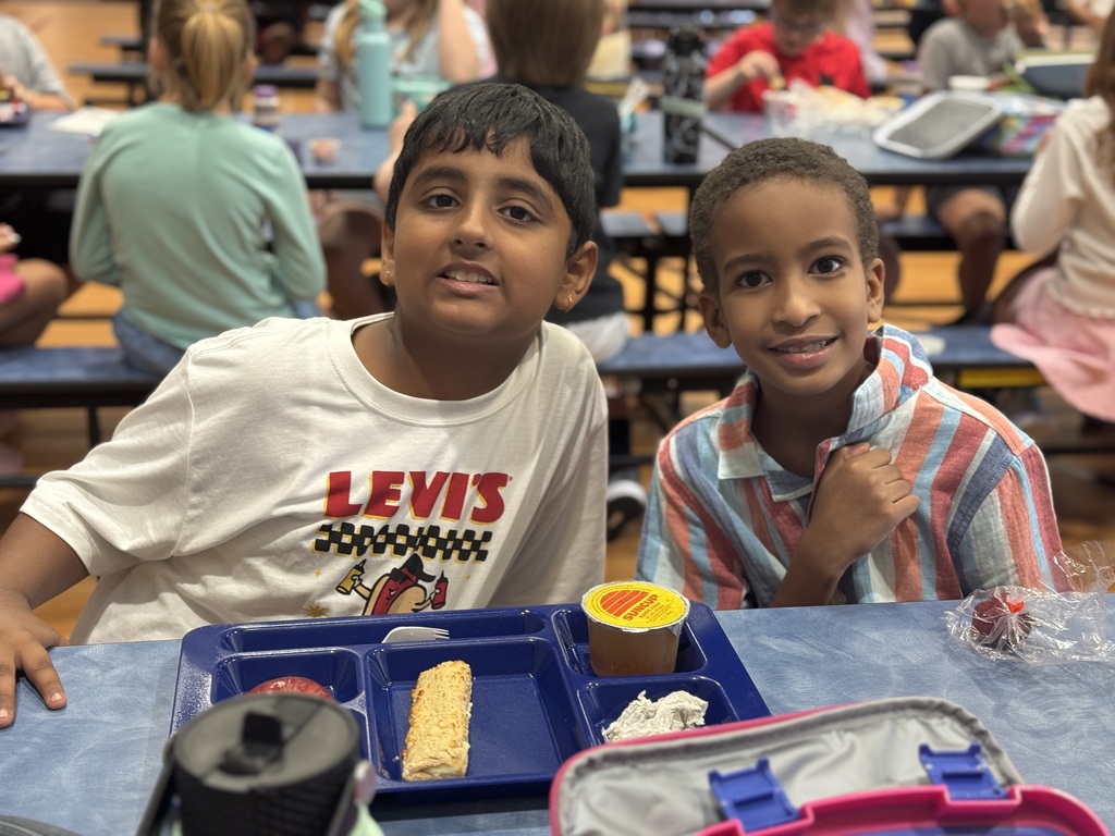 Students smile together at lunch.