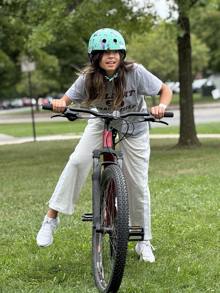 Students learn striding on a bike.