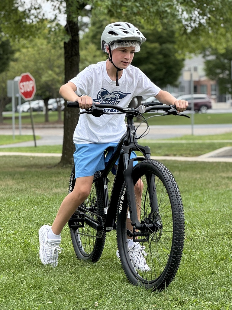 Students learn striding on a bike.