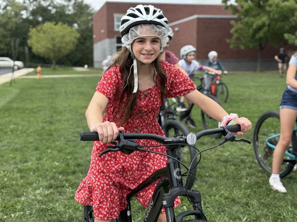 Students learn striding on a bike.