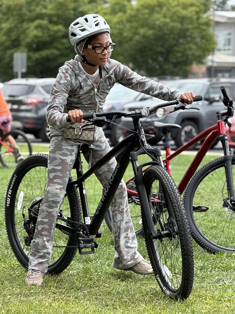 Students learn striding on a bike.