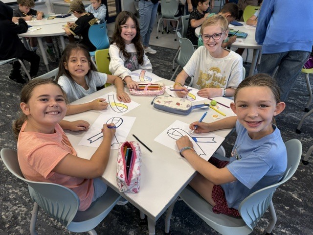 Students color yellow ribbons.