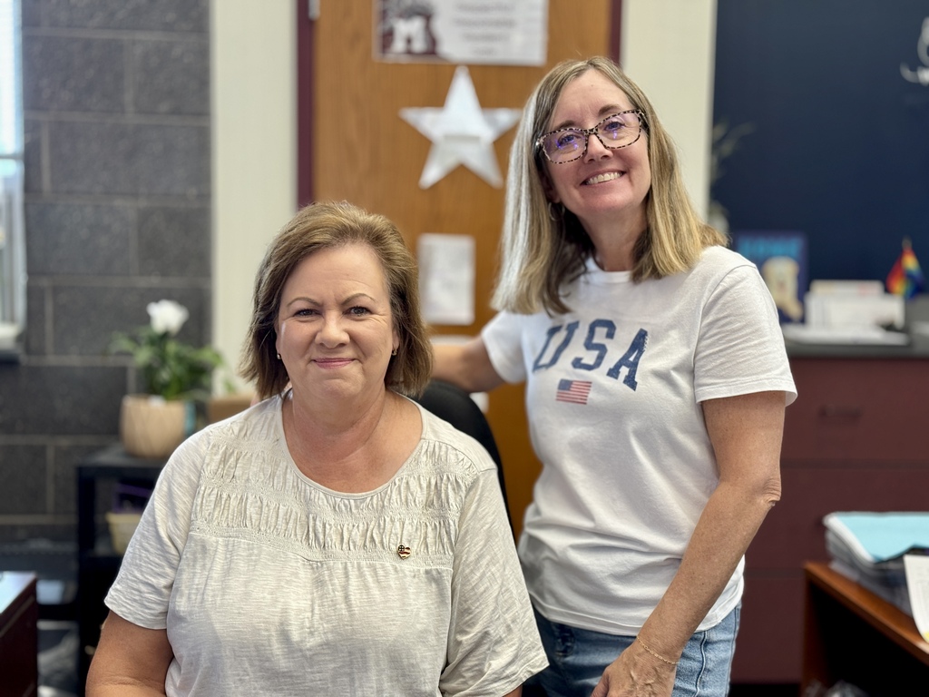Two staff members proudly wear red, white, and blue.