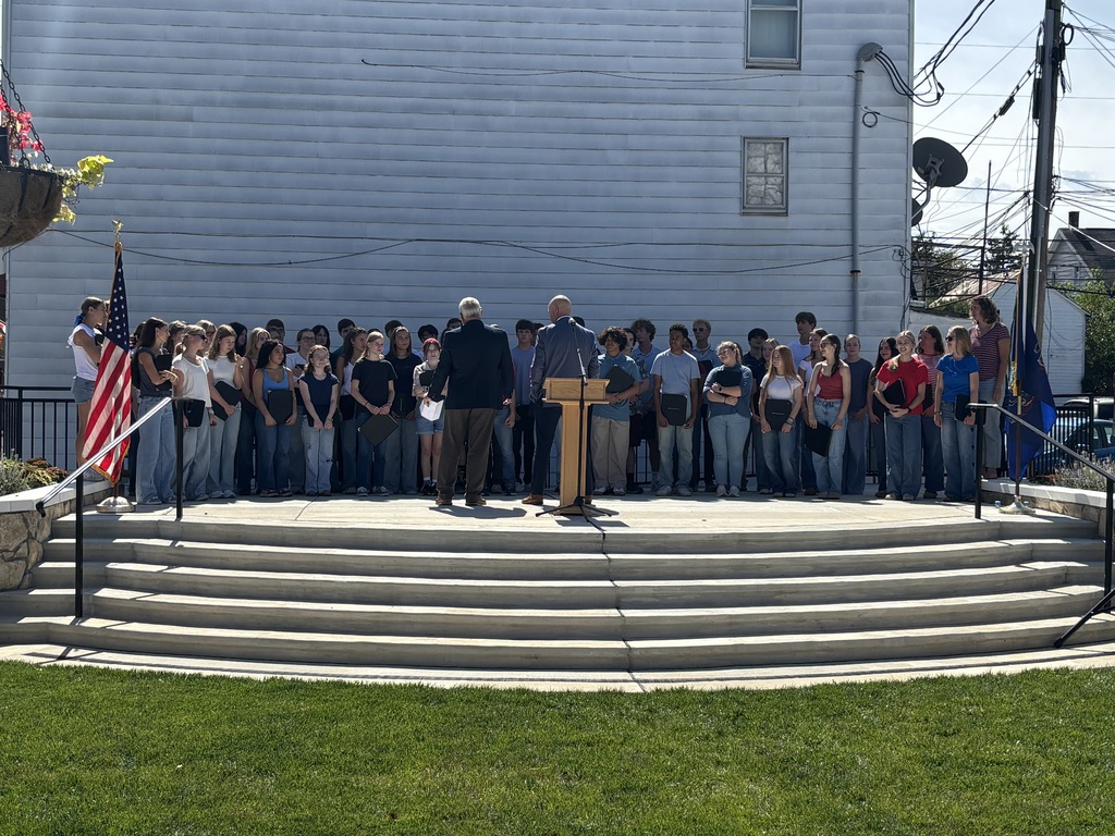 Students sing on stage.