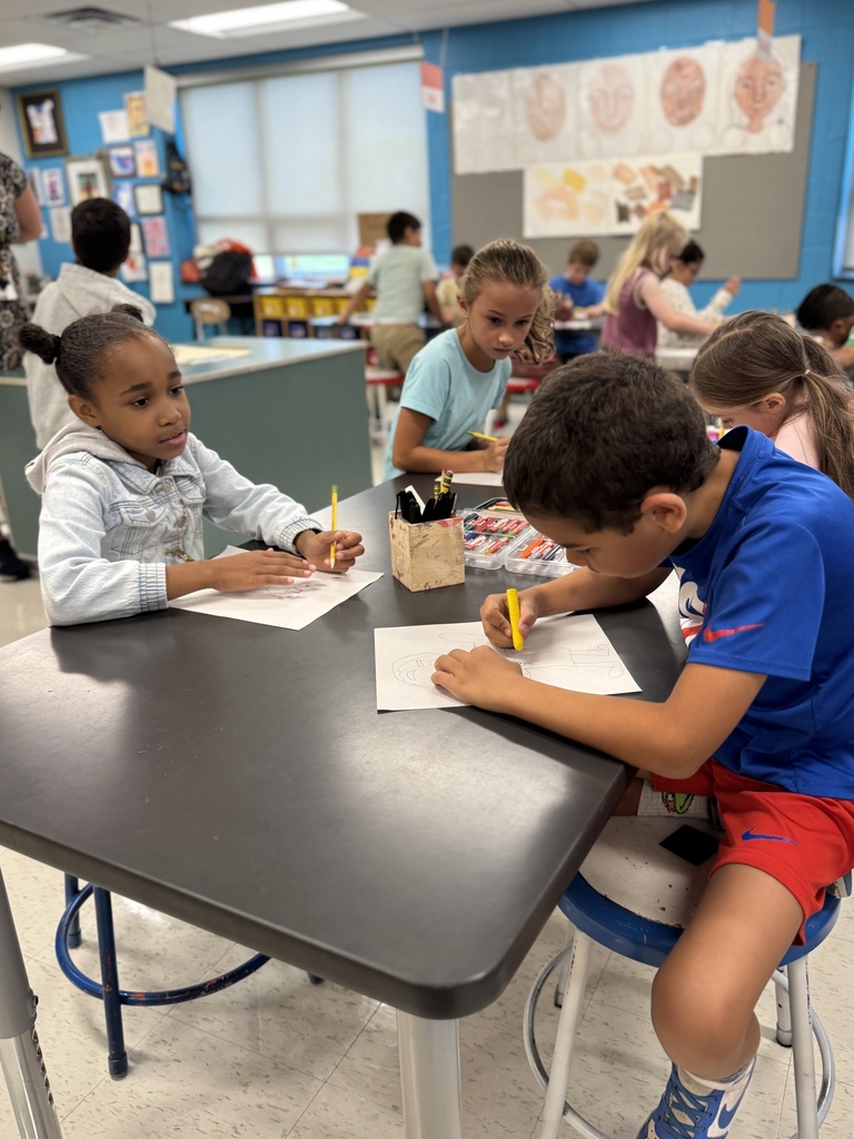 Students draw in art class.
