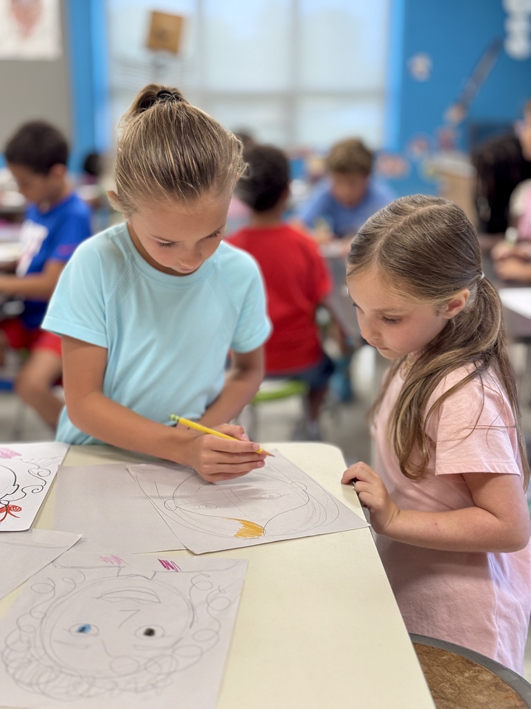 Students draw in art class.