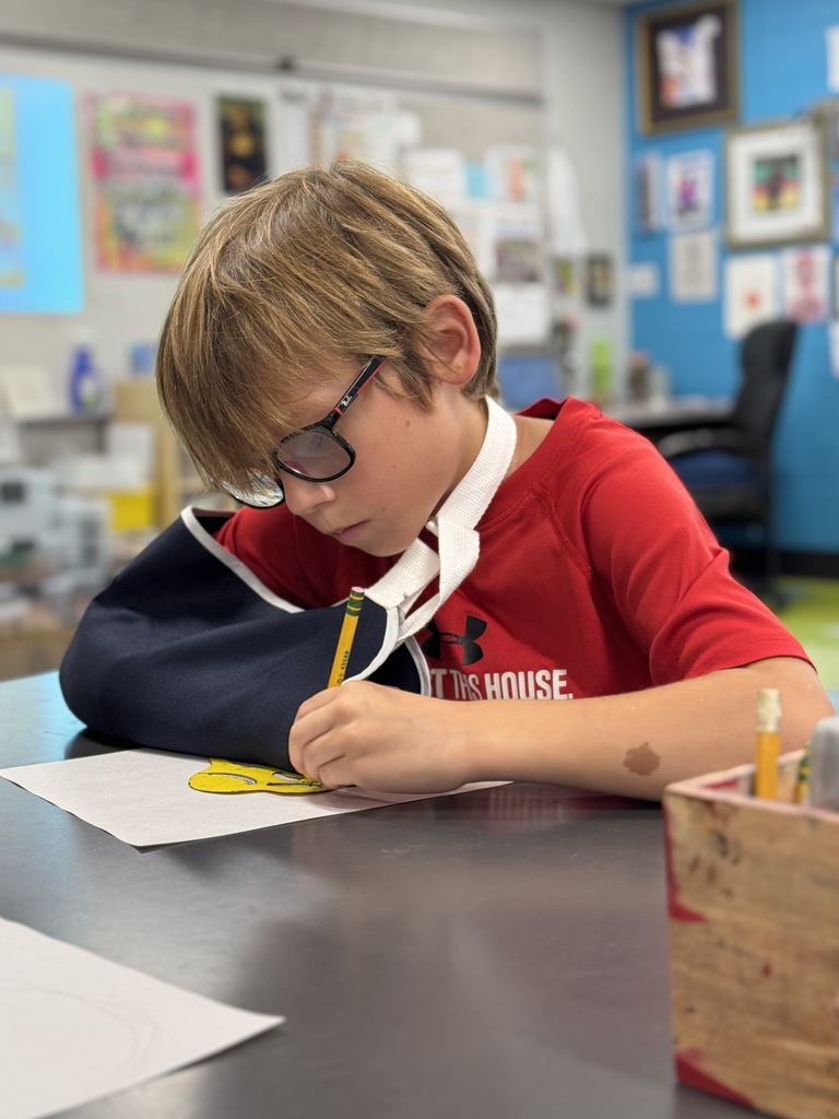 Students draw in art class.