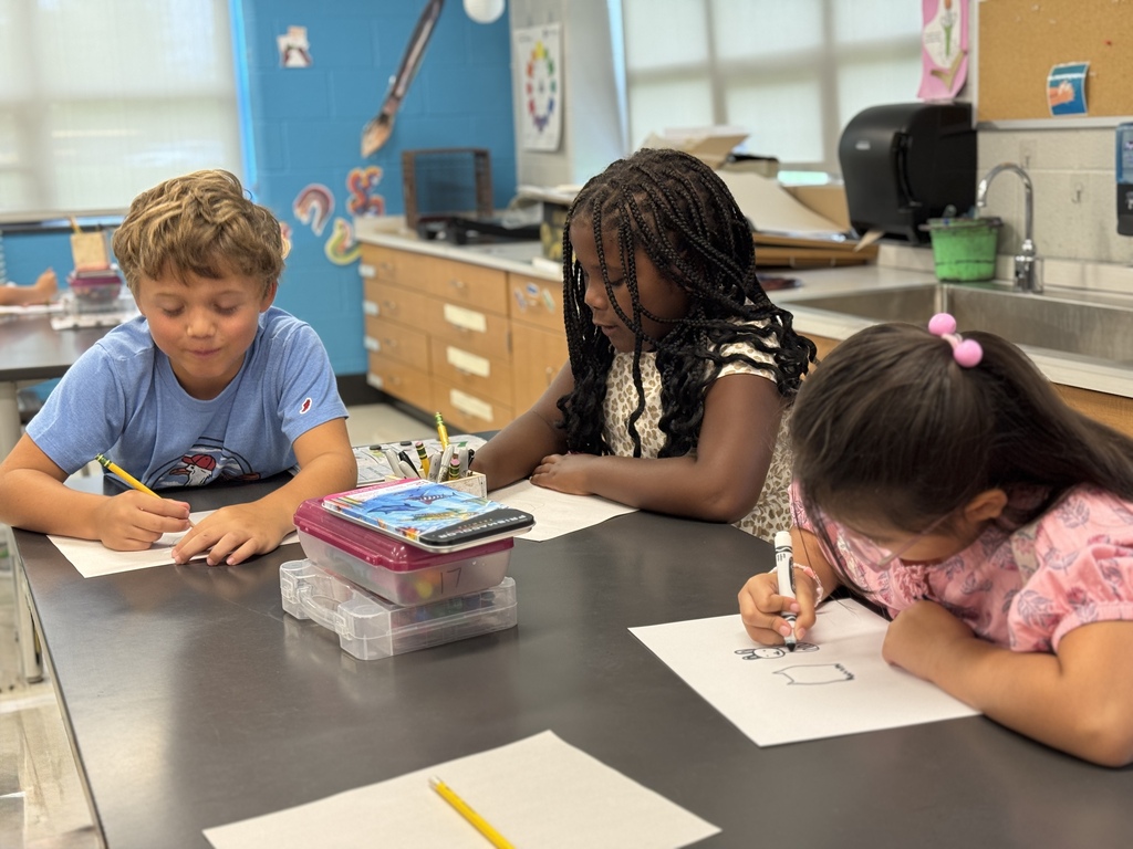 Students draw in art class.