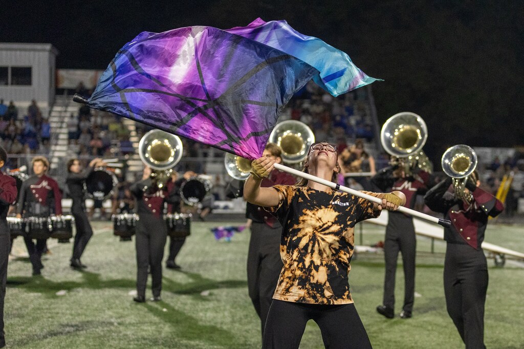 A marching band performs during a football game.