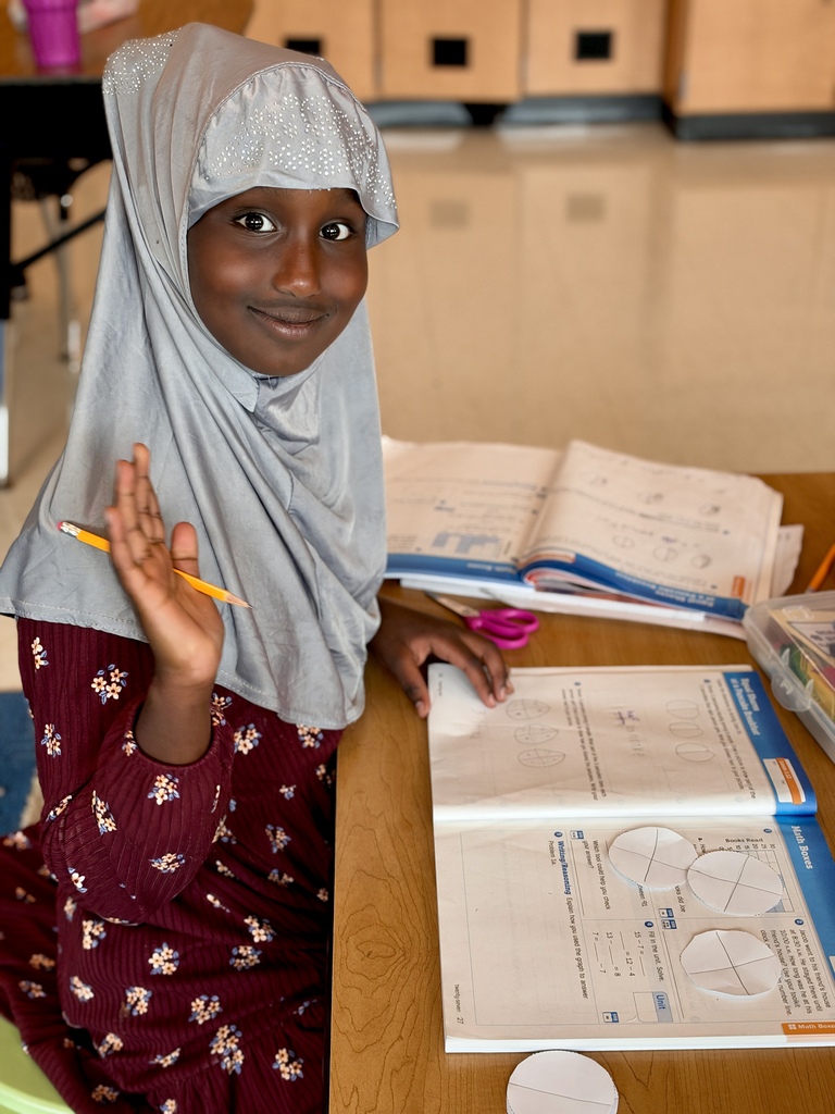A young student works on a math worksheet.
