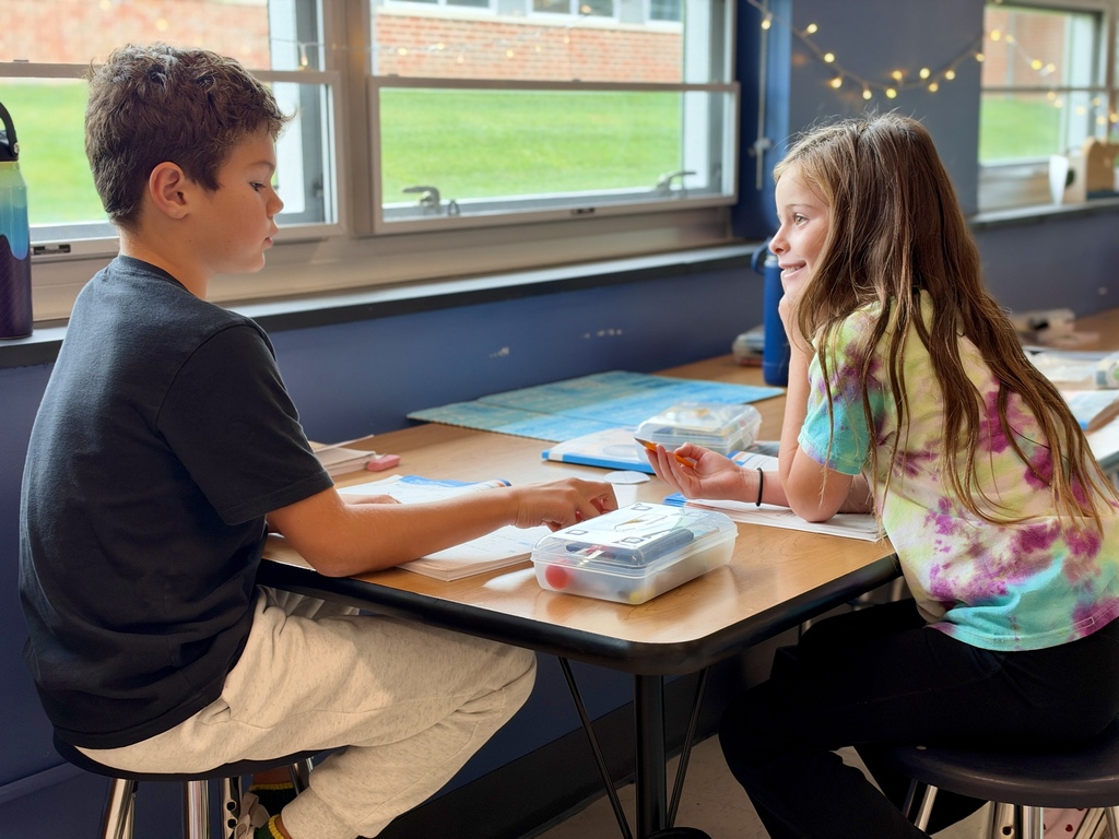Two students work together on a math assignment.