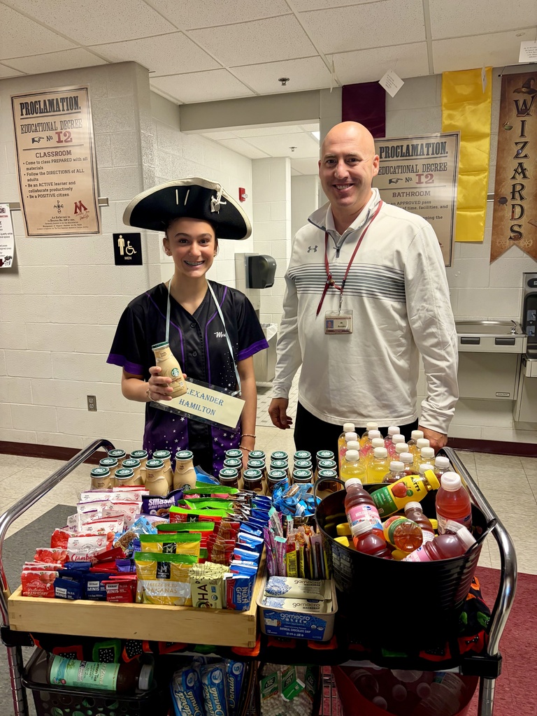 Staff stand behind a snack cart.