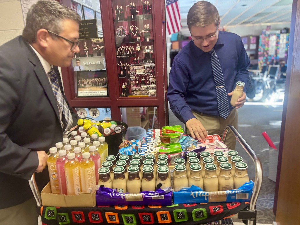 A man selects a snack from a cart.