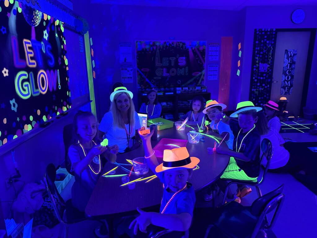 Students have a glow in the dark party in their classroom.