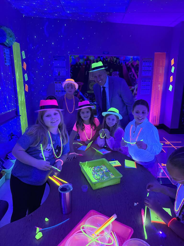 Students have a glow in the dark party in their classroom.