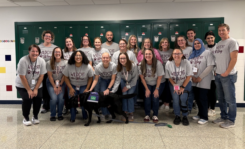 A group of teachers all show off their new Wildcat Wing tshirts.