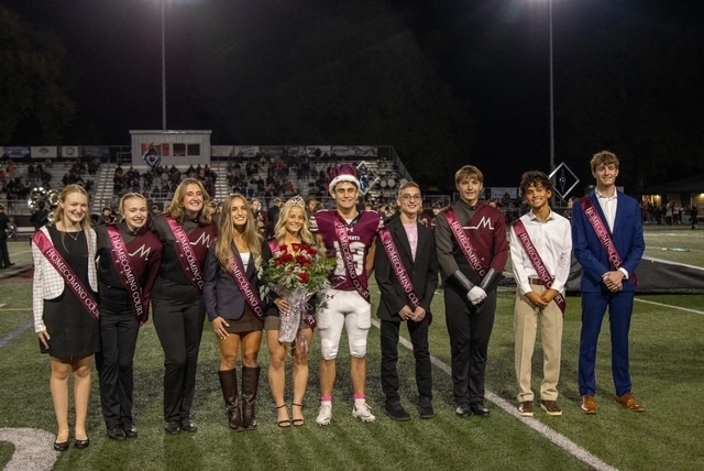 Homecoming court lines the football field.