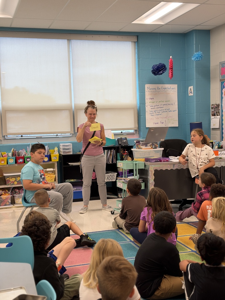 A teacher holds up a card as part of a lesson on tricky words.