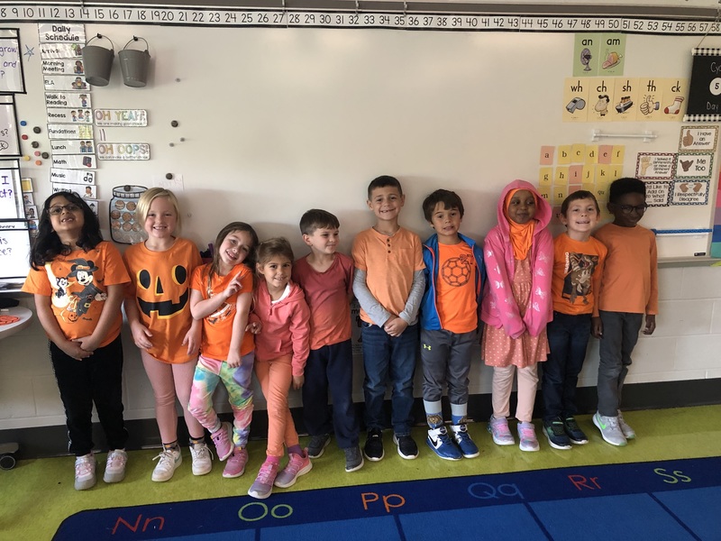 group of kids wearing orange