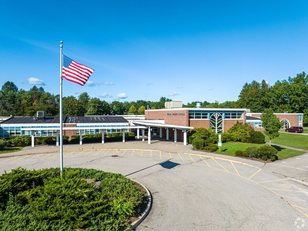 image of outside of school building with flag pole