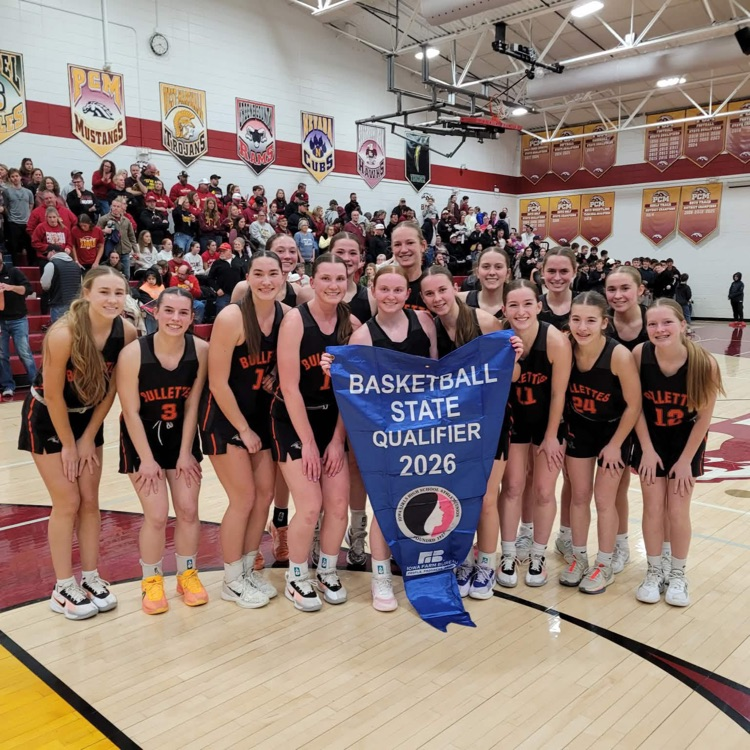 girls basketball team holding state qualifier banner