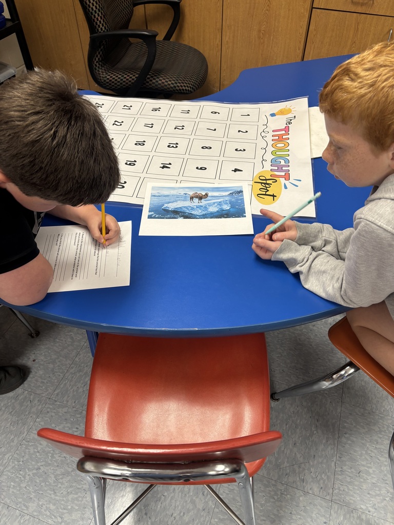 students looking at pictures and writing about them.