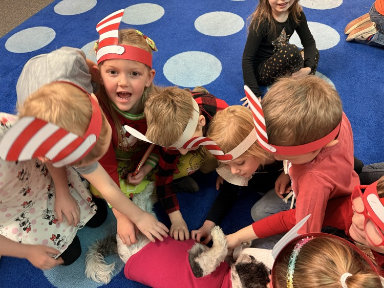 Scarlett soaking up the belly scratches from the loving preschoolers after the read aloud 