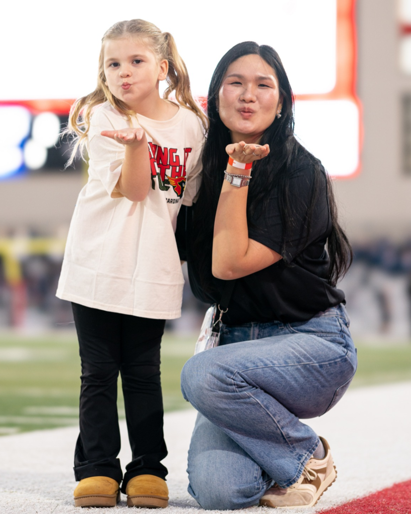 Penny with Dr. Chi in Coach Kenny Deel Stadium before the Varsity Football Game