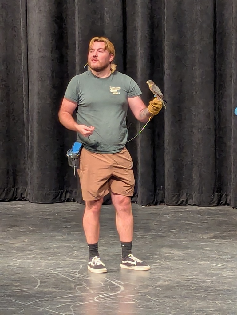 man in green shirt with small bird