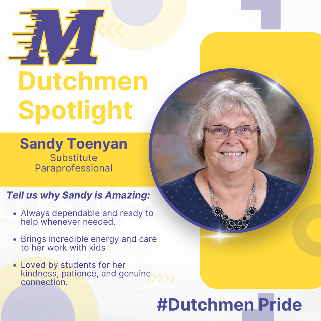 Woman with short blonde hair, glasses, a necklace and a blue shirt