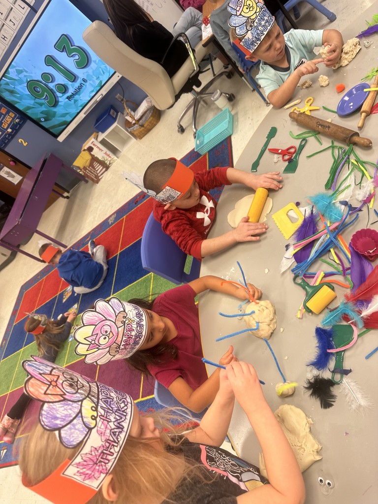 kids at a table playing with playdough and pipe cleaners and playdough