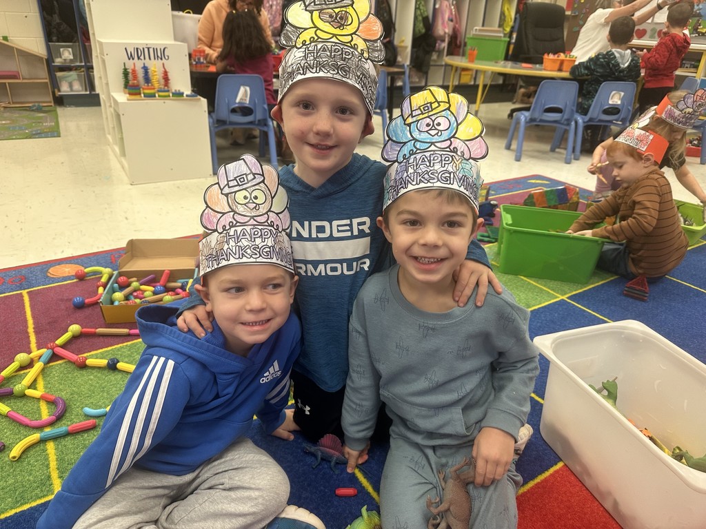 3 boys with blue shirts and turkey crowns