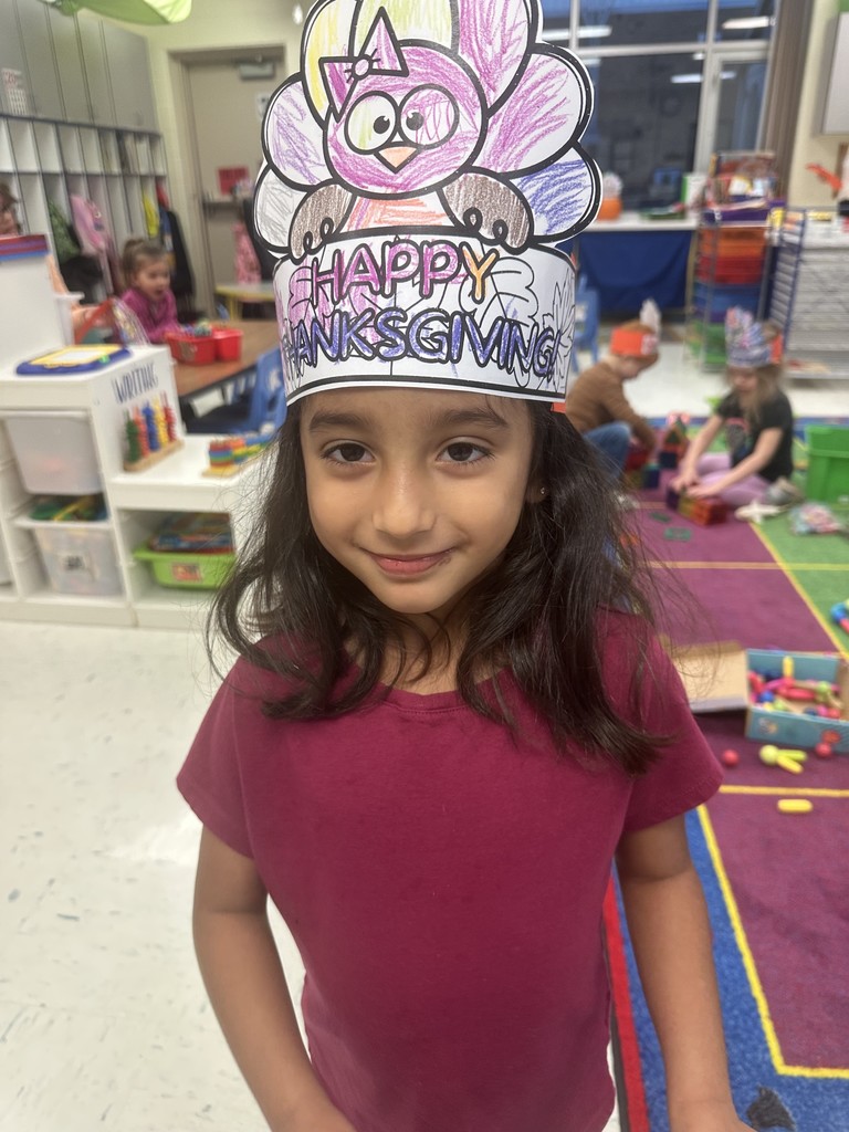 girl in red shirt with dark hair and a turkey crown