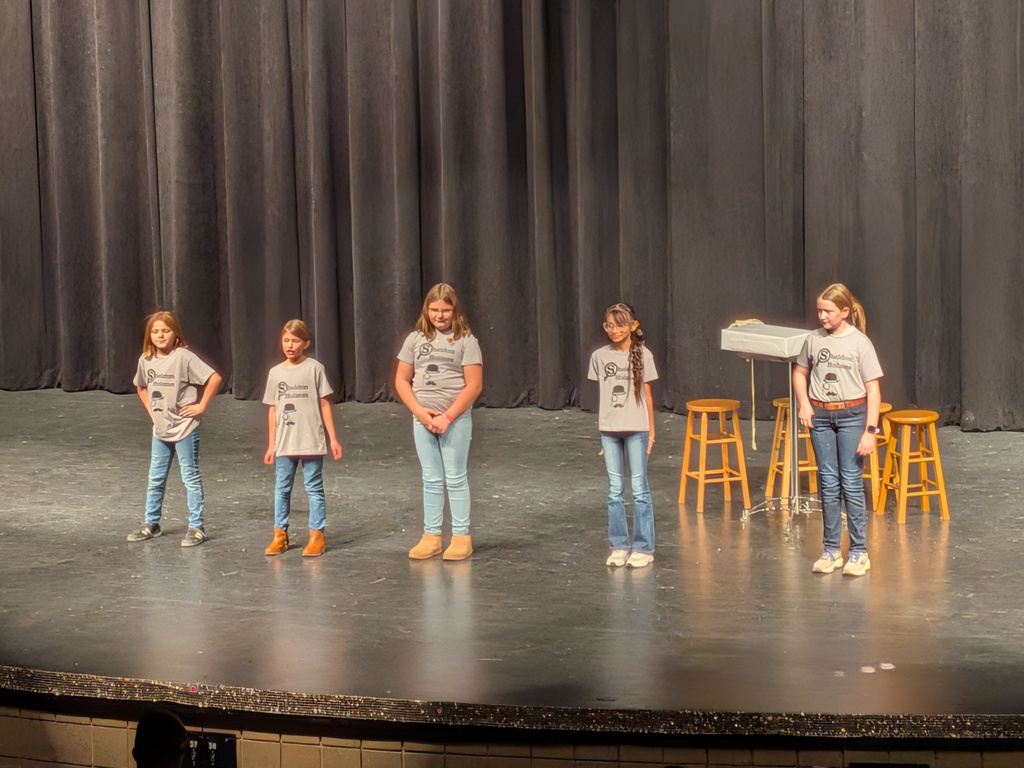 row of girl standing on stage