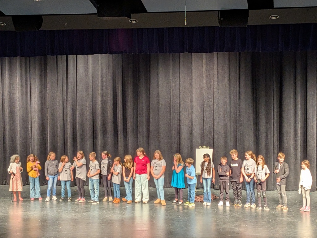 group of kids standing on a stage