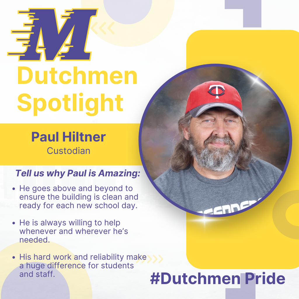 man with longer brown hair and a beard in a grey shirt and a red and blue Twins hat 