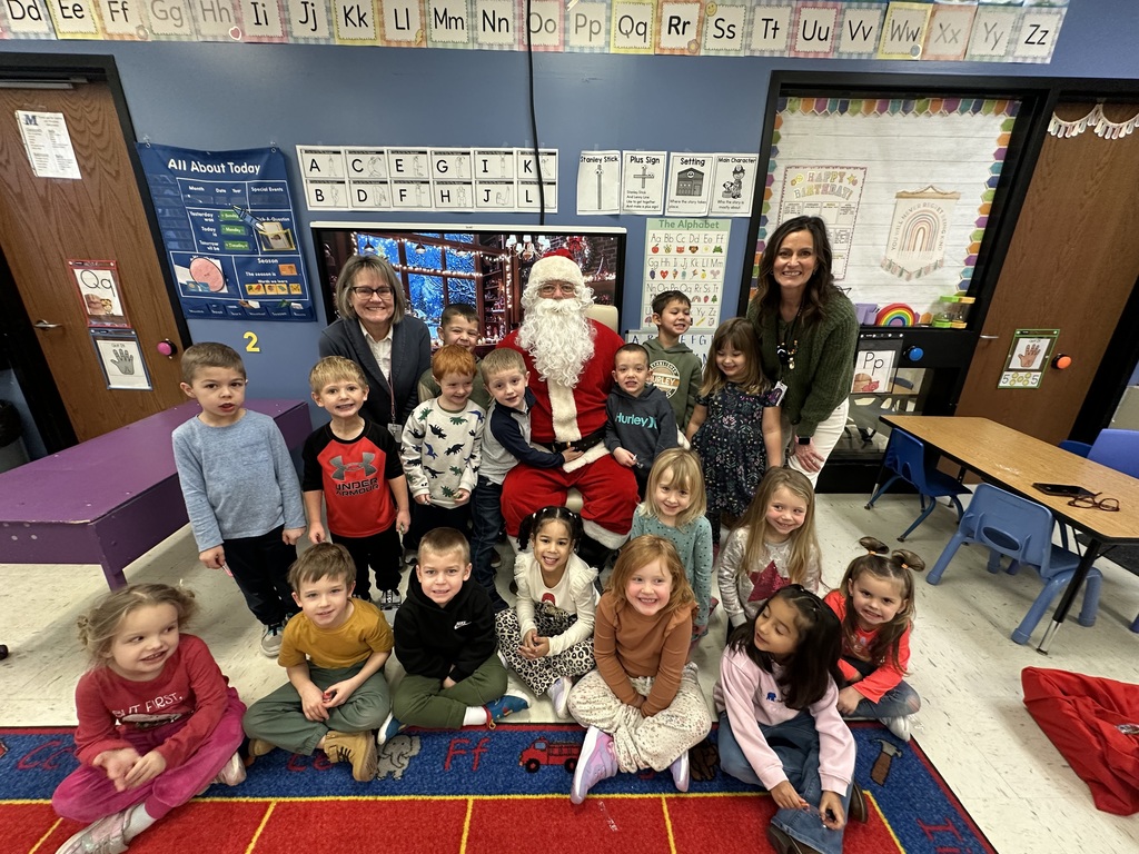 preschoolers and teacher posing with santa 