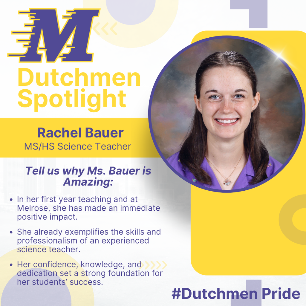 woman in a purple dress shirt, necklace brown long hair blue eyes and a smile