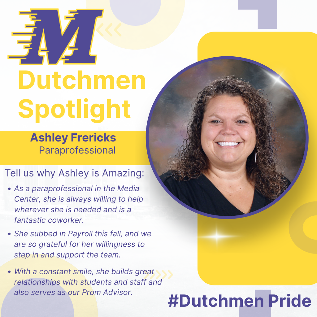 Woman in black shirt, brown curly hair and a big smile