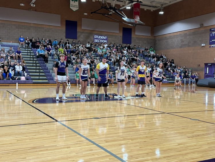 Football players join the cheerleaders in a dance