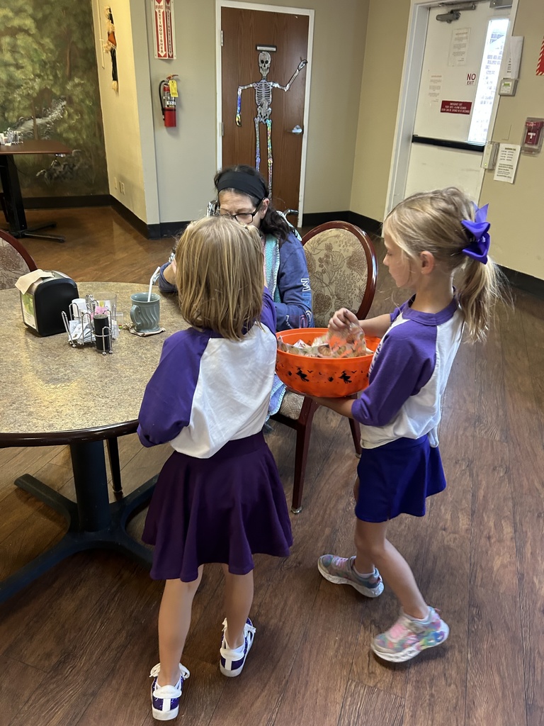 Photo shows the Robertsville Elementary Spirit Squad spending time with residents at the Pacific Care Center. 