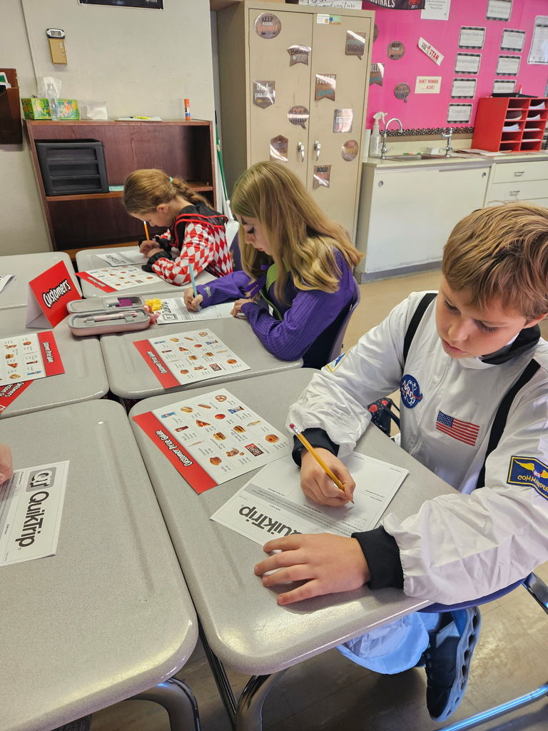The photo shows Pacific Intermediate 6th graders using a real-world approach to learn math.