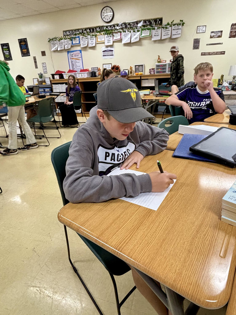 Photo shows students in Mrs. Vogt’s 7th grade English language arts classes writing letters for veterans participating in the Honor Flight program